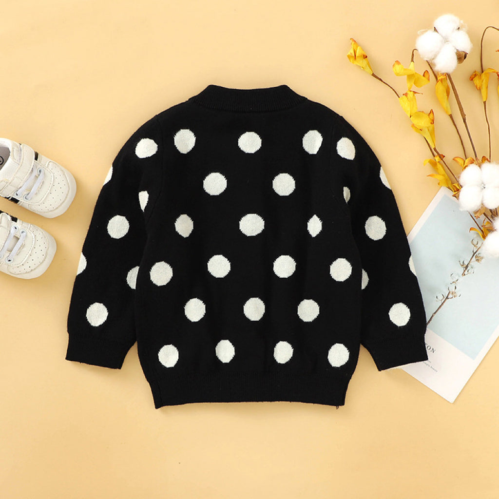 A stylish baby girl cardigan featuring a polka dot pattern and single breasted design, made from soft acrylic material.