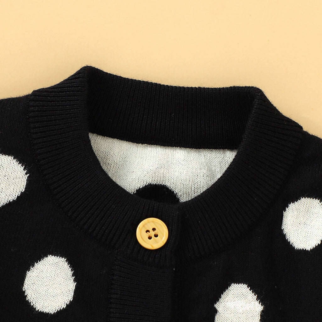 A stylish baby girl cardigan featuring a polka dot pattern and single breasted design, made from soft acrylic material.