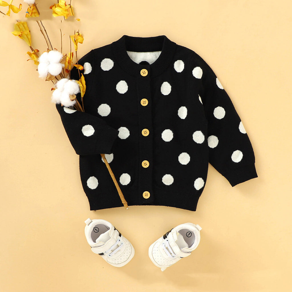 A stylish baby girl cardigan featuring a polka dot pattern and single breasted design, made from soft acrylic material.