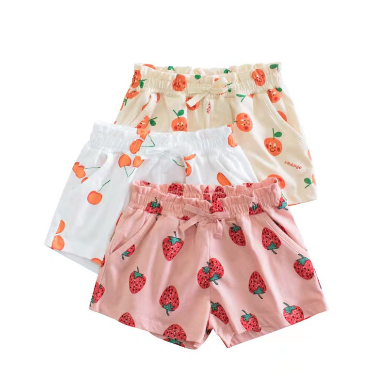 Baby girl summer shorts with vibrant print patterns and bow decoration, available in multiple colors.