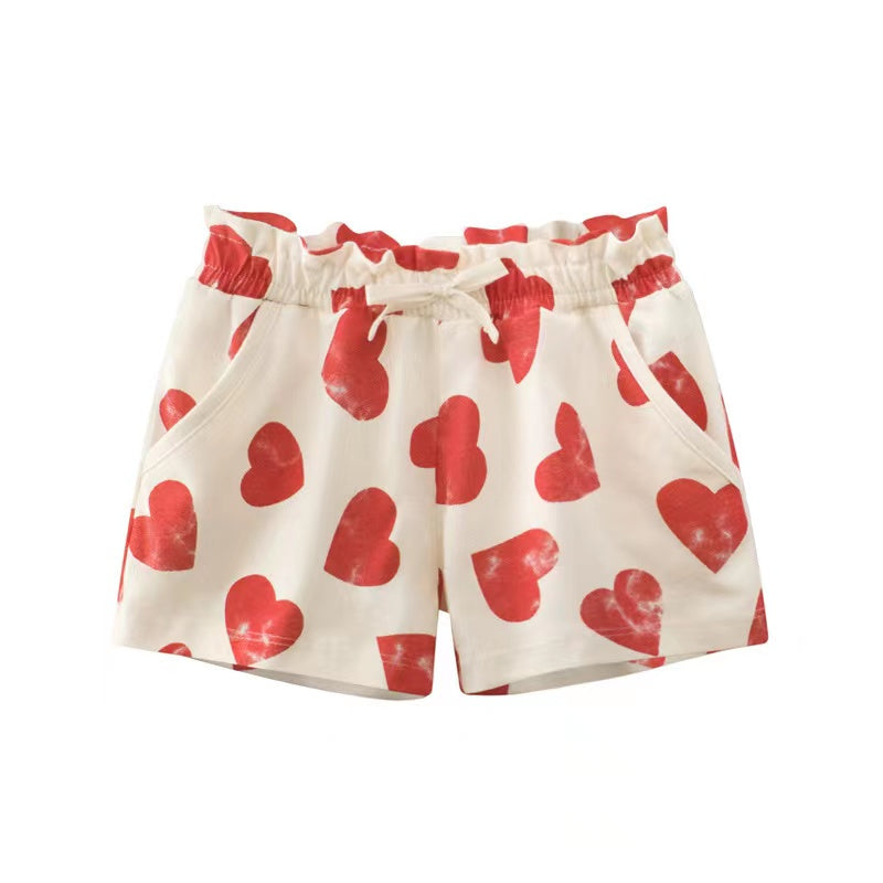 Baby girl summer shorts with vibrant print patterns and bow decoration, available in multiple colors.