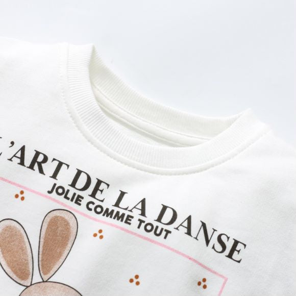 Baby girl wearing a white long sleeve cotton hoodie with a rabbit graphic, perfect for spring and autumn.