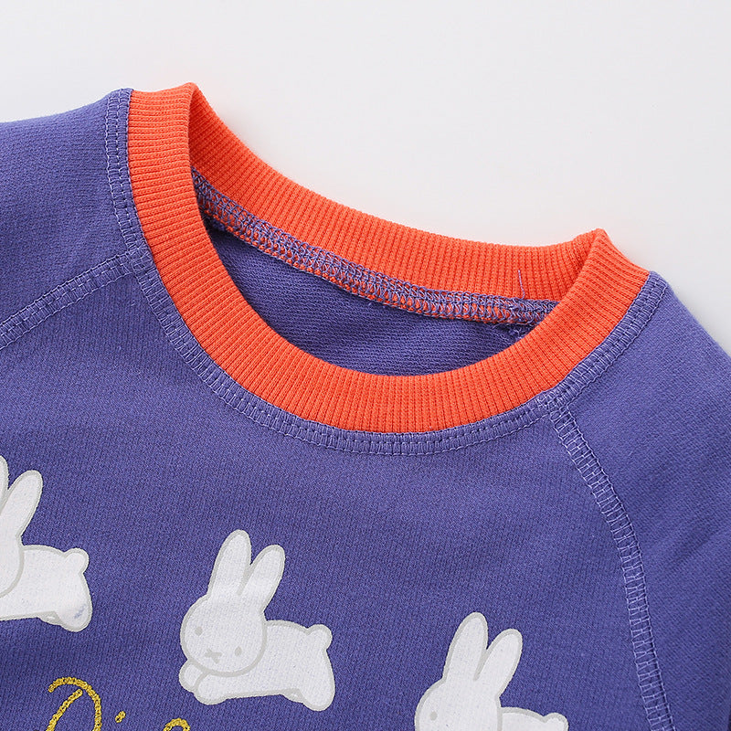 Baby girl wearing a blue rabbit print hoodie with colorblock design, showcasing a playful and stylish look.