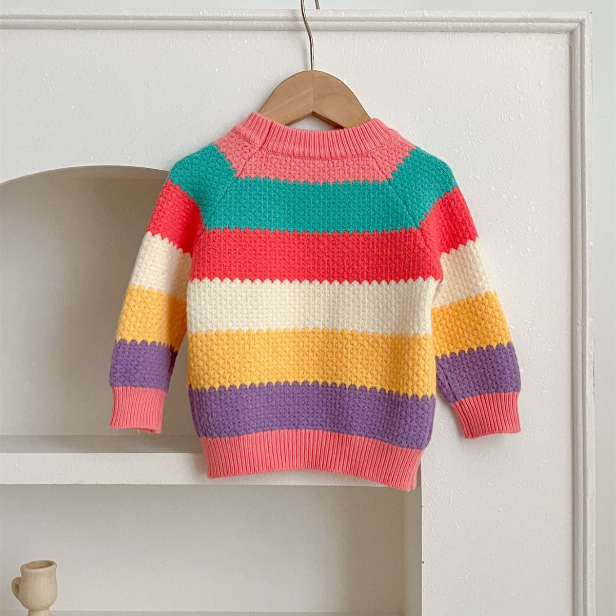 A colorful Baby Girl Rainbow Strips Knitting Pullover Sweater featuring vibrant rainbow stripes, perfect for stylish and cozy wear.