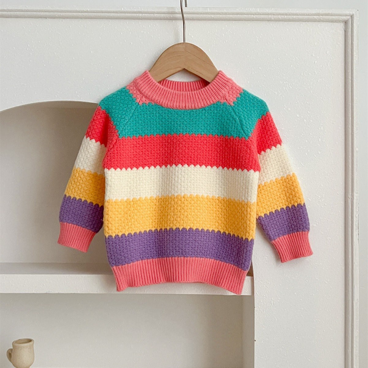 A colorful Baby Girl Rainbow Strips Knitting Pullover Sweater featuring vibrant rainbow stripes, perfect for stylish and cozy wear.