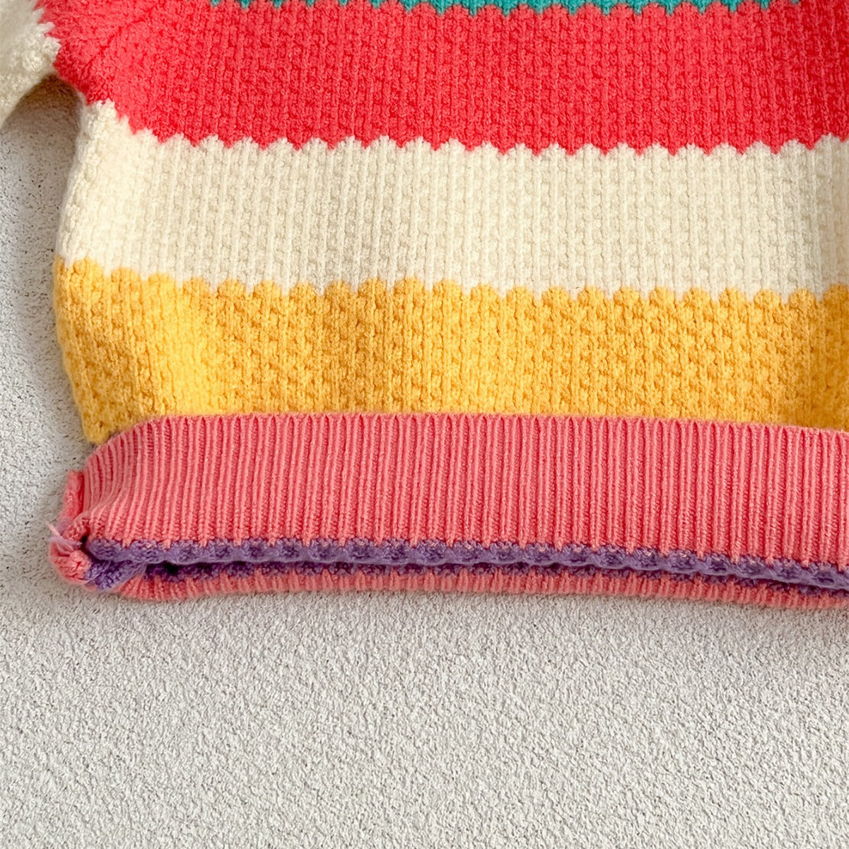 A colorful Baby Girl Rainbow Strips Knitting Pullover Sweater featuring vibrant rainbow stripes, perfect for stylish and cozy wear.