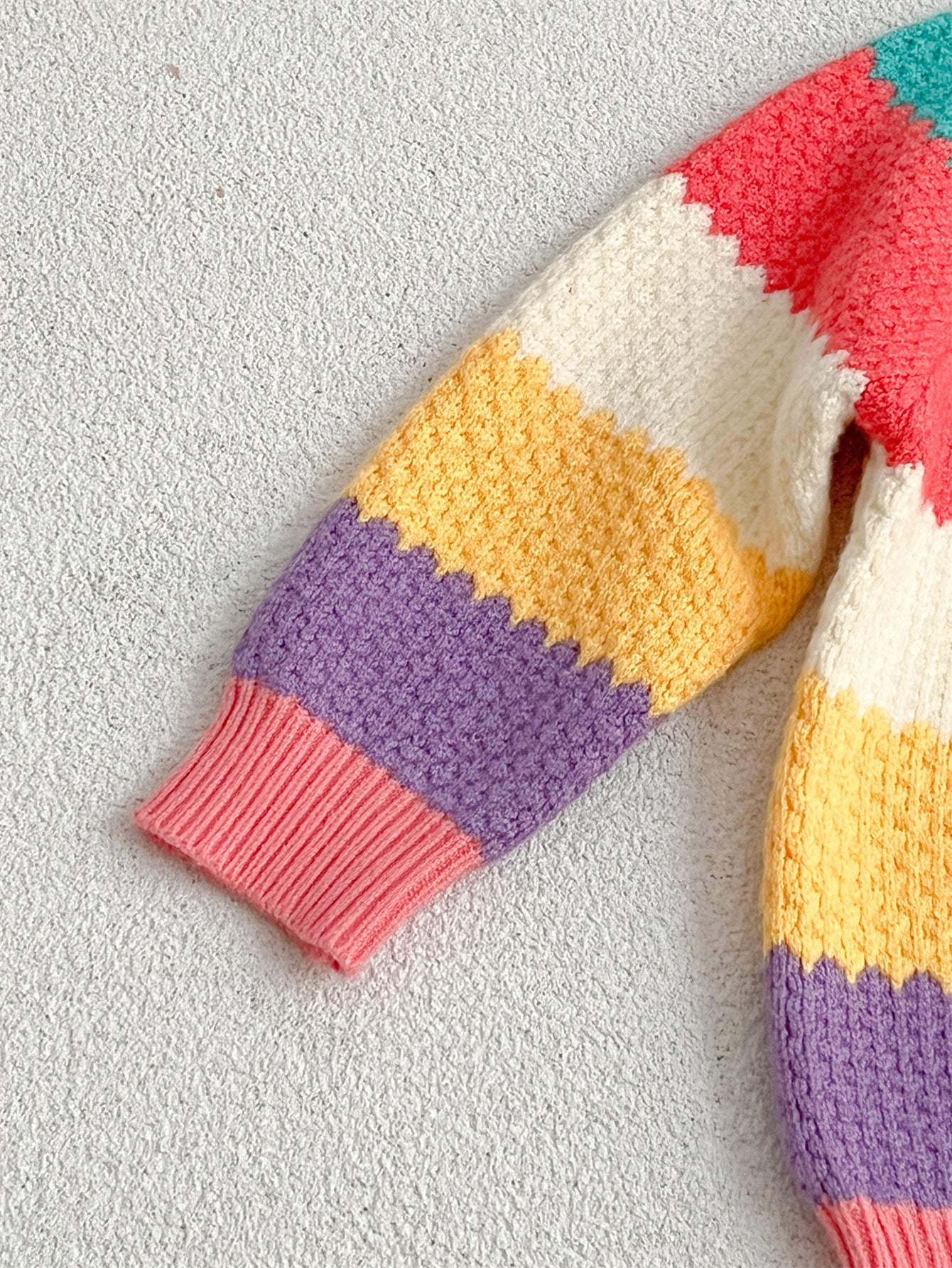 A colorful Baby Girl Rainbow Strips Knitting Pullover Sweater featuring vibrant rainbow stripes, perfect for stylish and cozy wear.