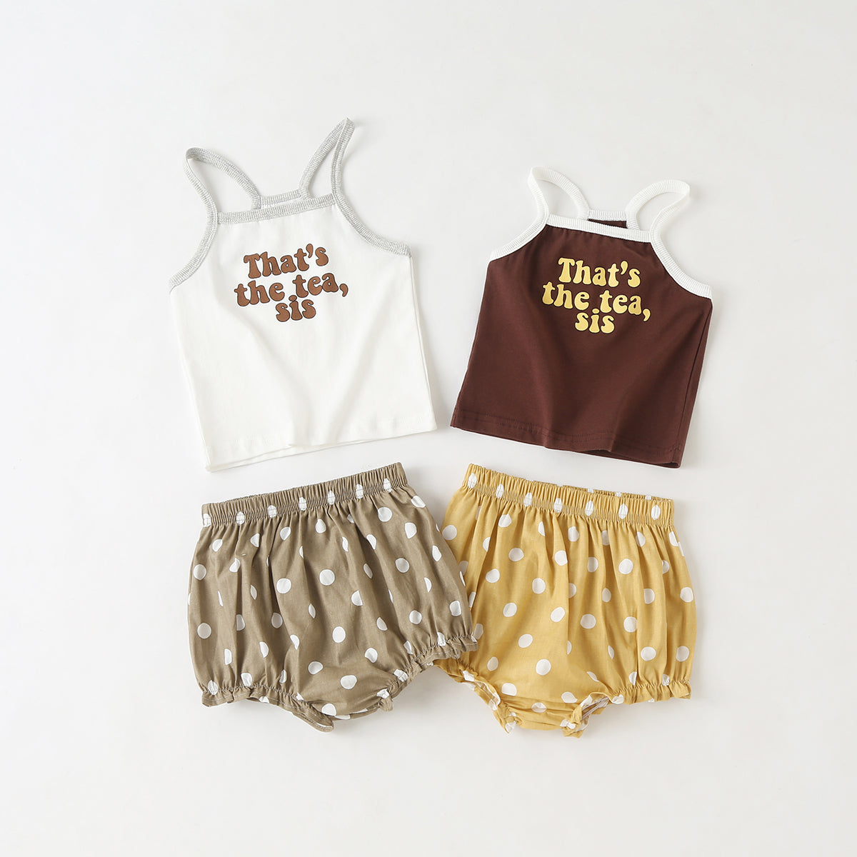 Baby girl outfit featuring a slogan pattern sling top and polka dot shorts with triangle detail, available in white and coffee colors.