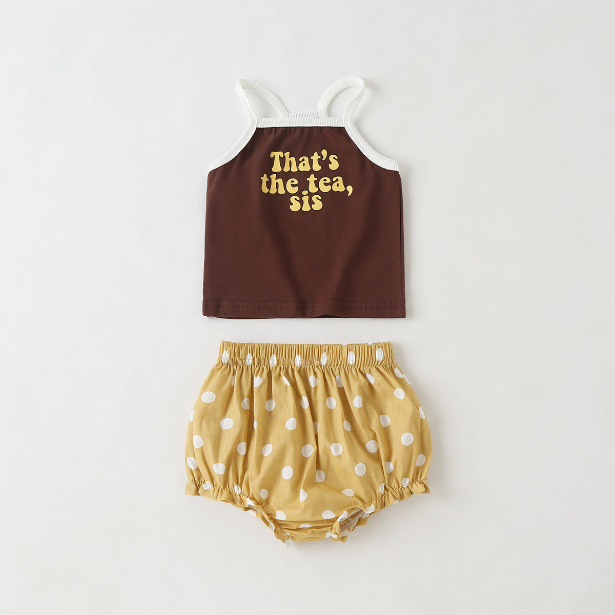 Baby girl outfit featuring a slogan pattern sling top and polka dot shorts with triangle detail, available in white and coffee colors.