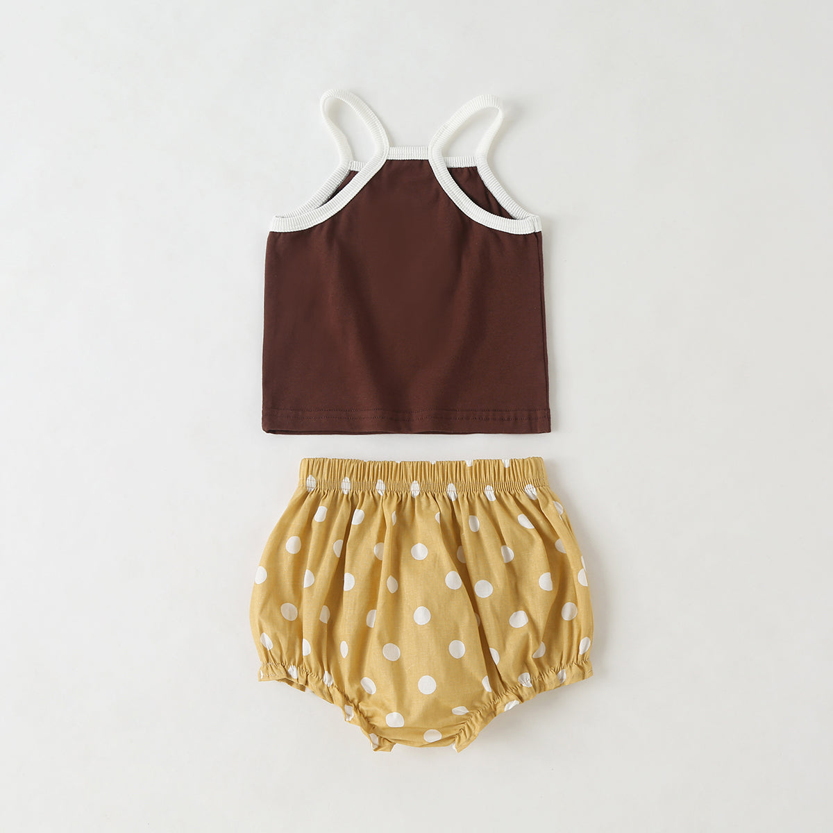 Baby girl outfit featuring a slogan pattern sling top and polka dot shorts with triangle detail, available in white and coffee colors.