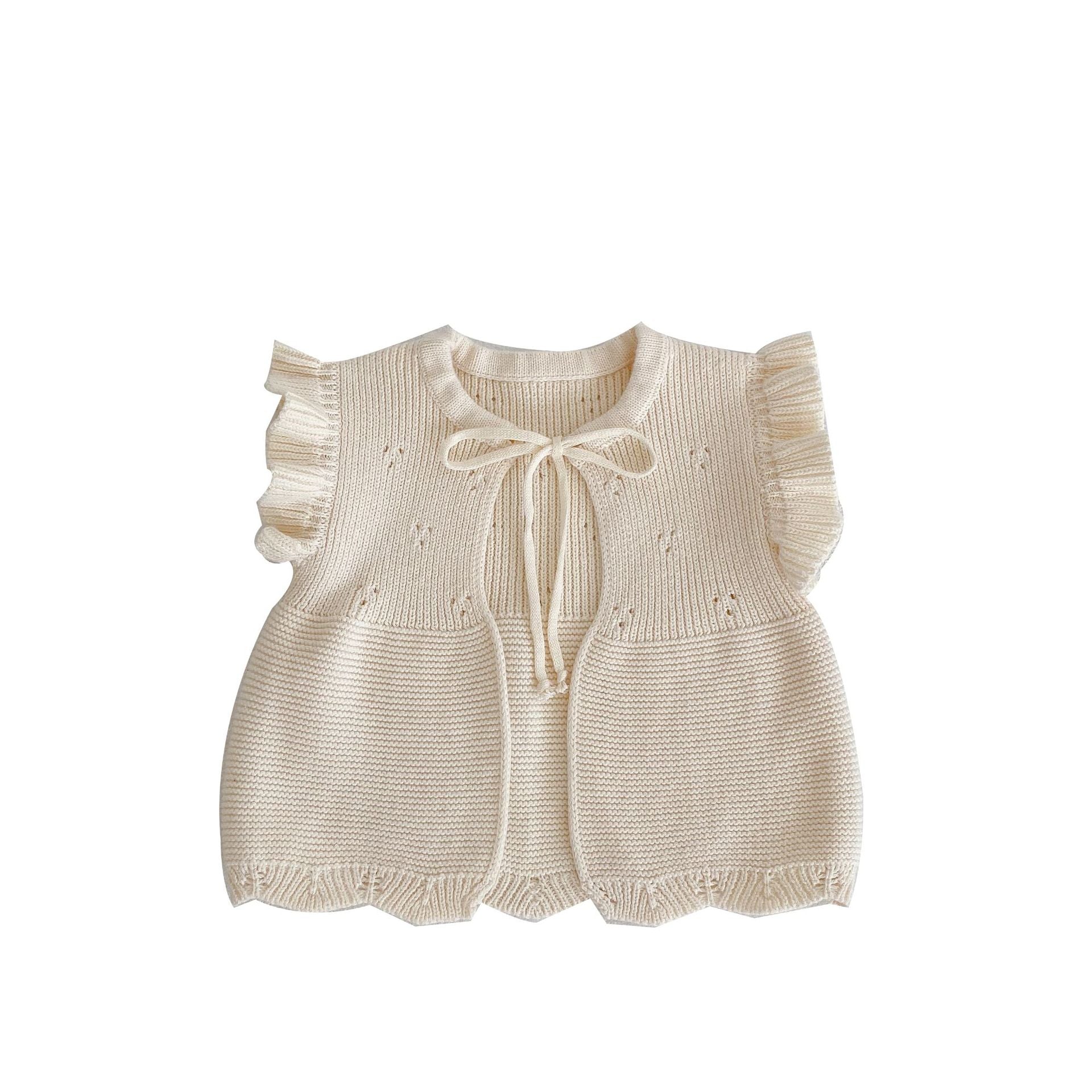 Baby girl wearing a solid color cardigan with butterfly sleeves, showcasing a cute and stylish design.