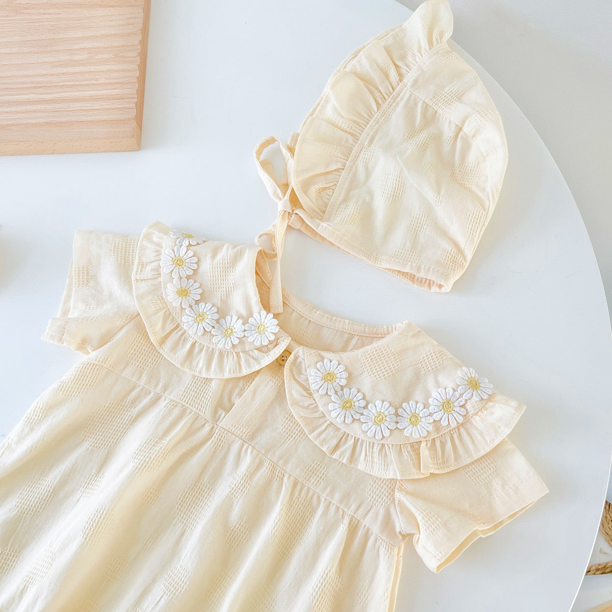 Baby girl apricot onesies with floral pattern and doll neck design, made from soft cotton for summer comfort.