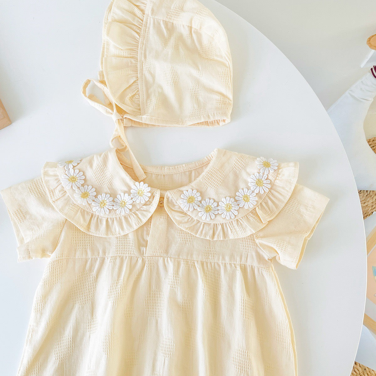 Baby girl apricot onesies with floral pattern and doll neck design, made from soft cotton for summer comfort.