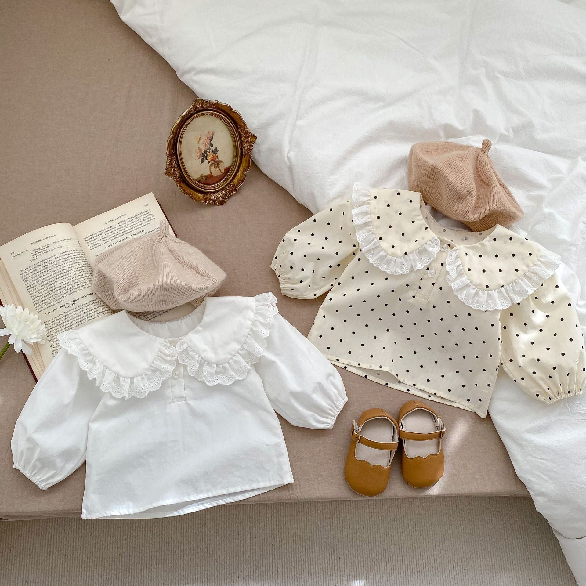 Baby girl solid color long sleeve blouse with doll neck design in white and beige, made from soft cotton material.