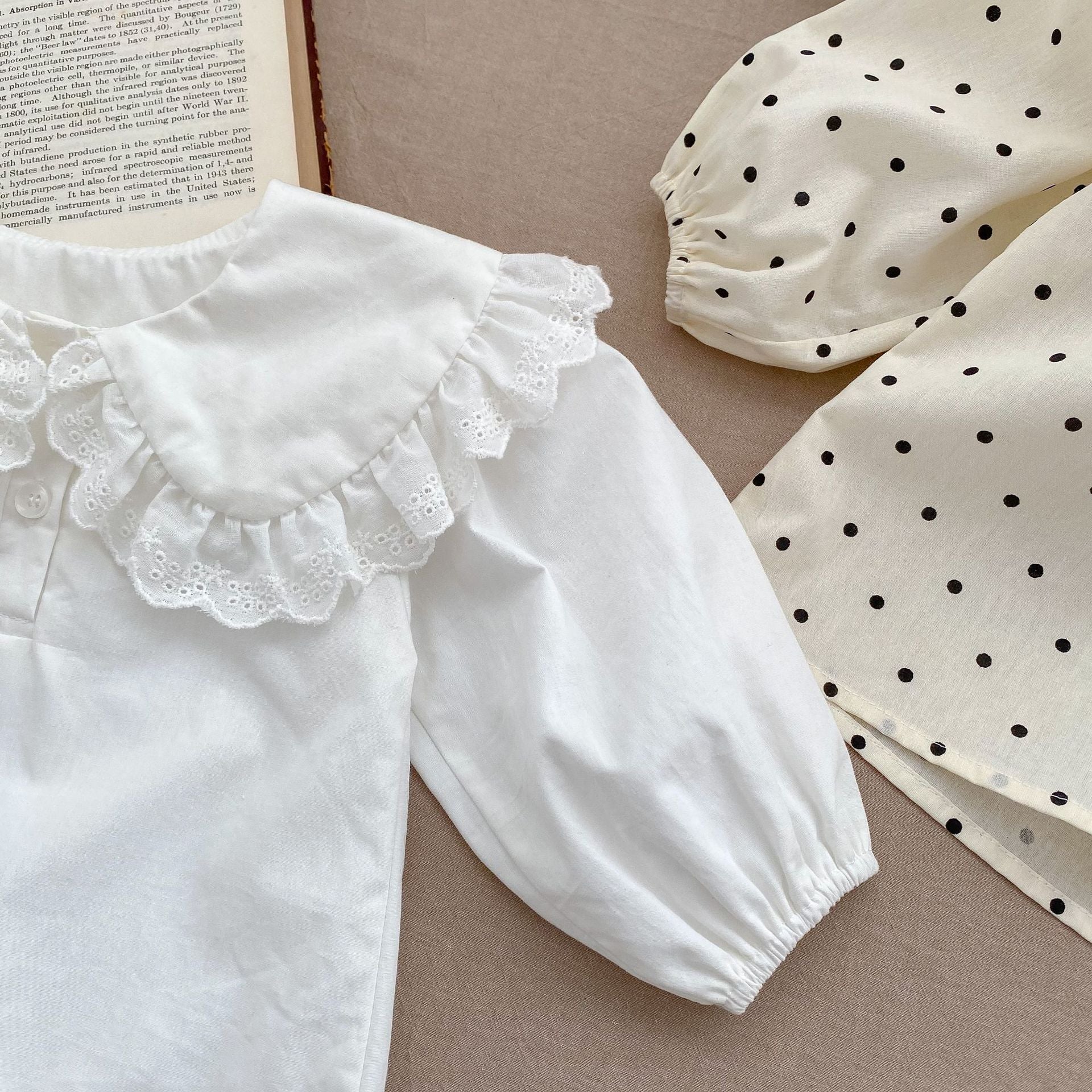 Baby girl solid color long sleeve blouse with doll neck design in white and beige, made from soft cotton material.