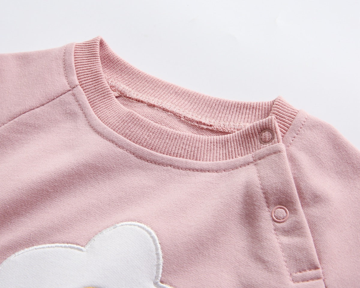 Baby girl onesie in pink with floral embroidery and pocket, made from soft cotton fabric.