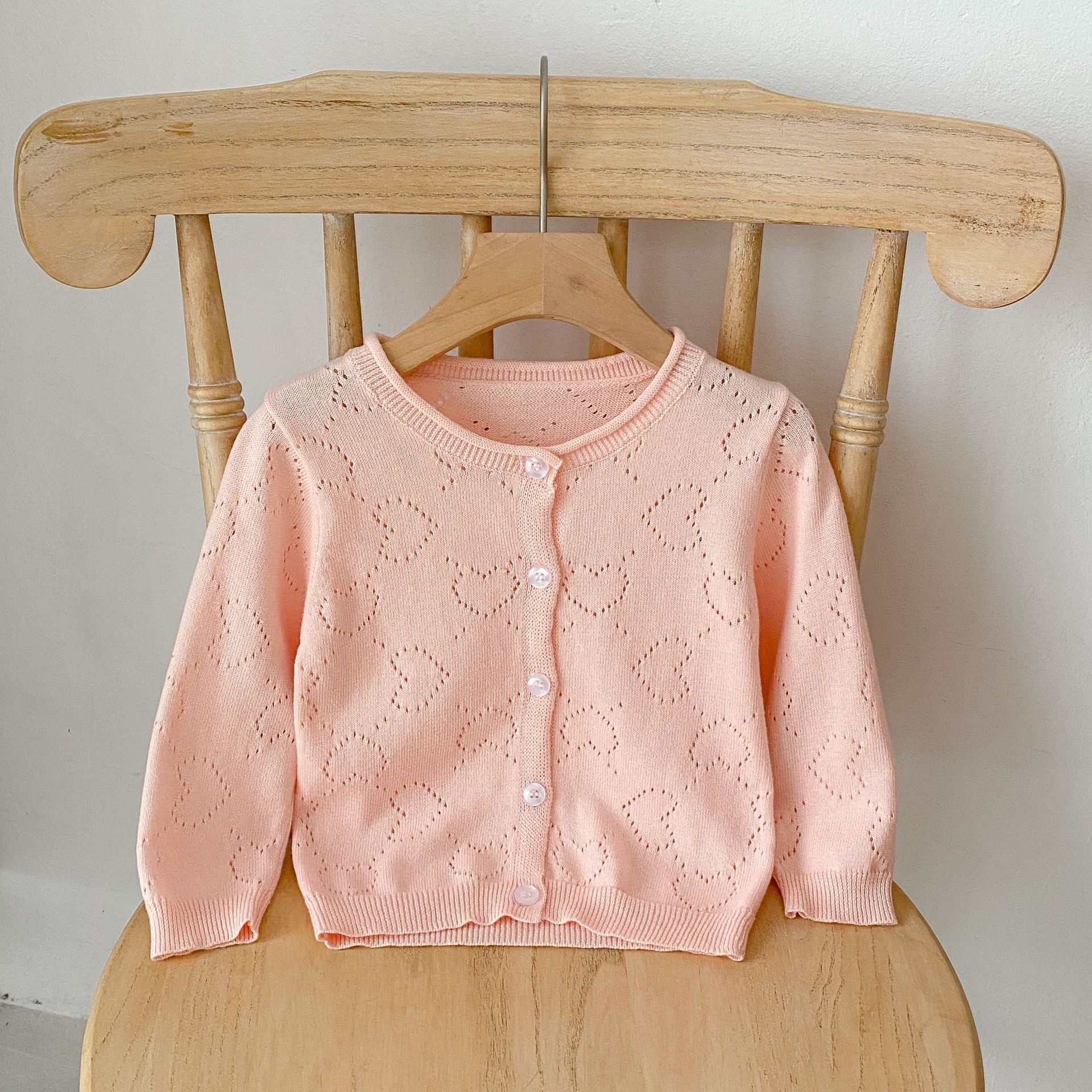 Baby girl cardigan in solid colors with heart hollow carved design, perfect for spring and autumn wear.