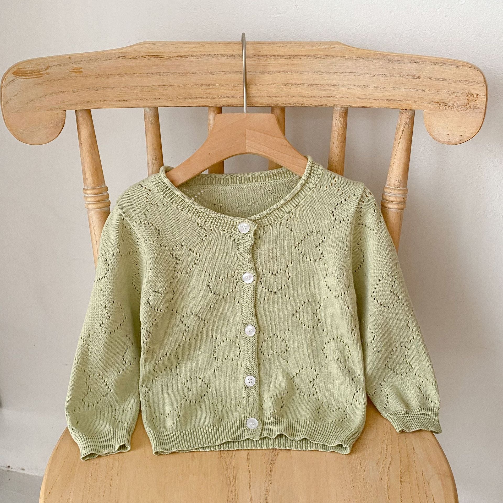 Baby girl cardigan in solid colors with heart hollow carved design, perfect for spring and autumn wear.