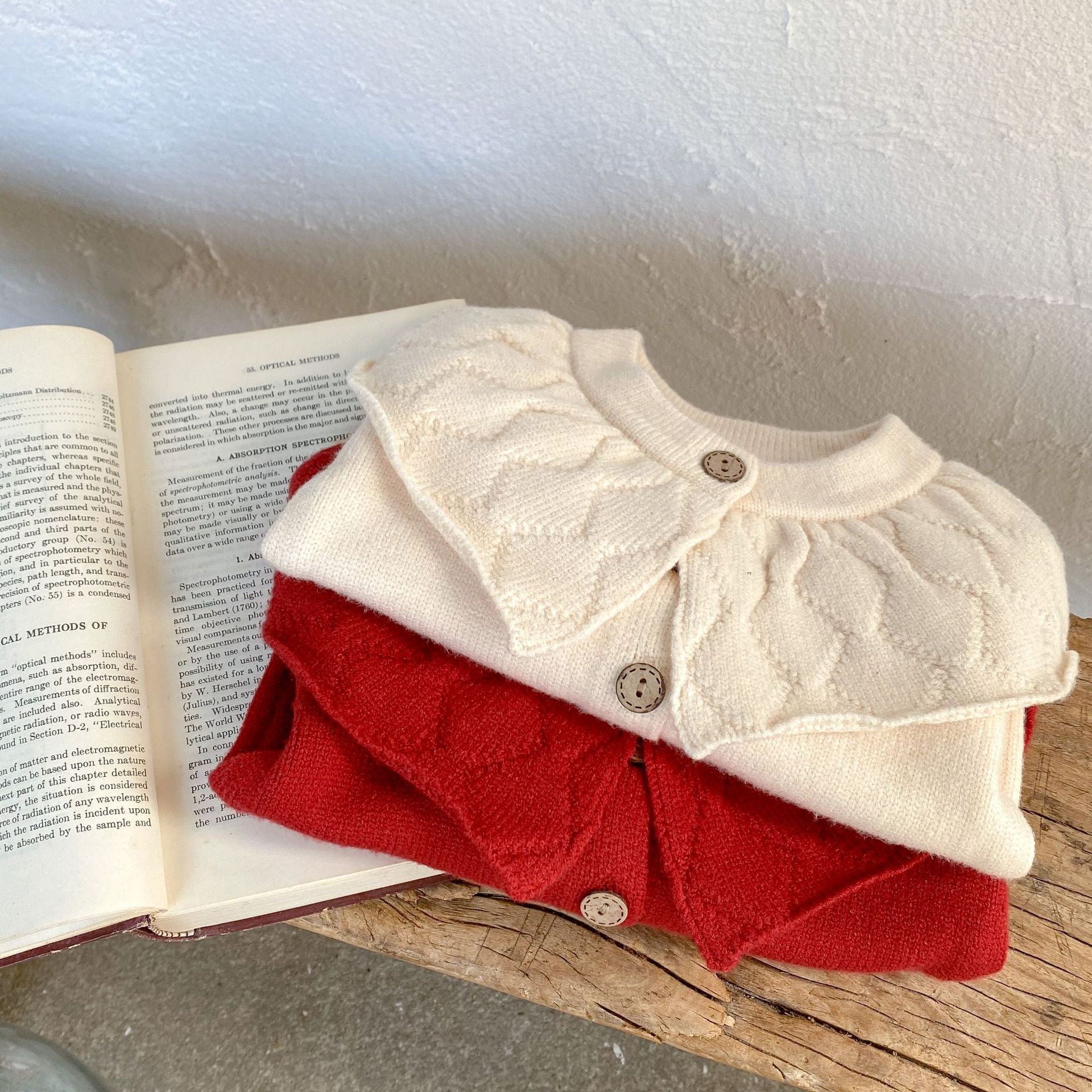 Baby girl solid color knit cardigan with lapel design in white and red, made from soft cotton fabric.