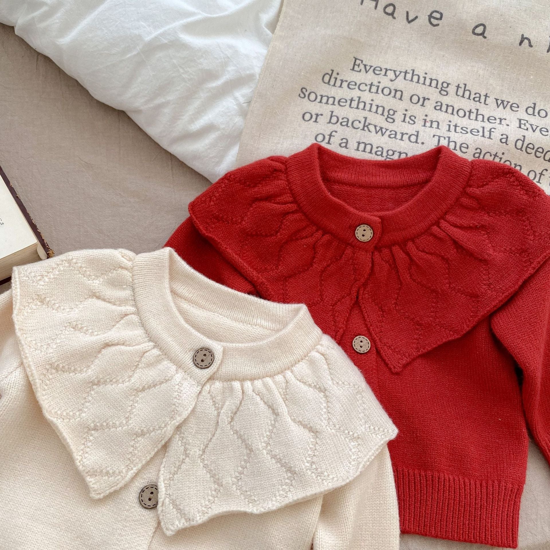 Baby girl solid color knit cardigan with lapel design in white and red, made from soft cotton fabric.