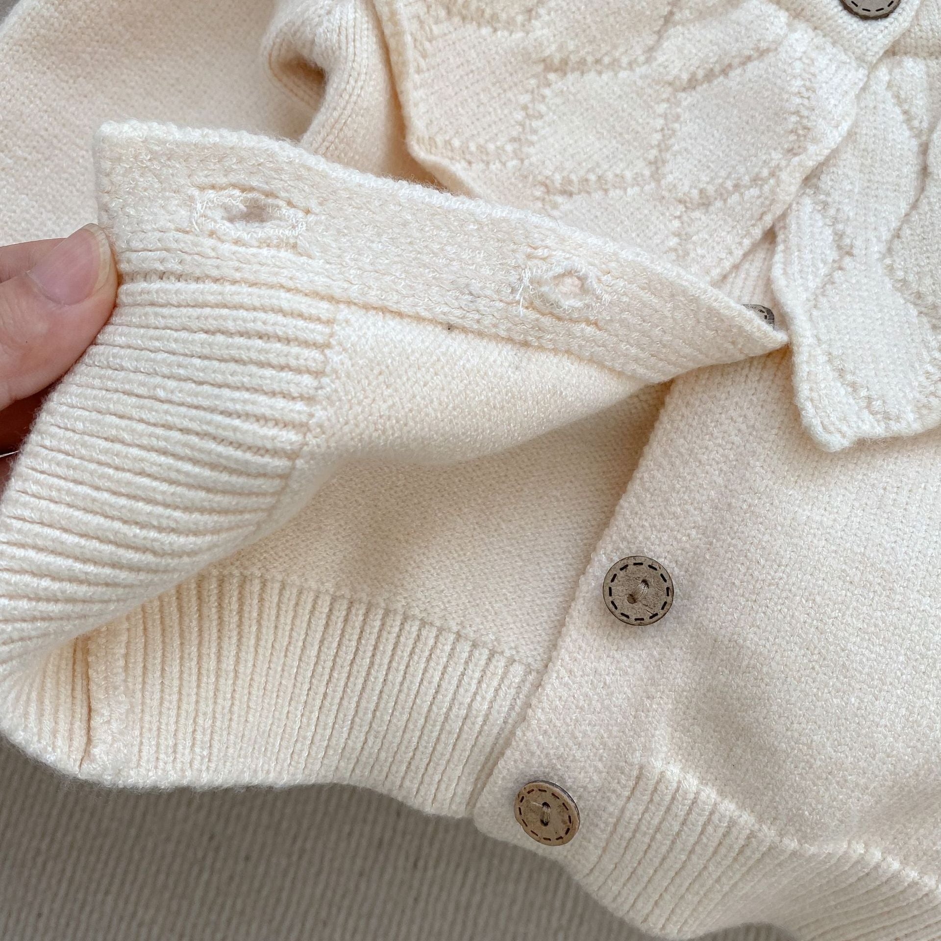 Baby girl solid color knit cardigan with lapel design in white and red, made from soft cotton fabric.