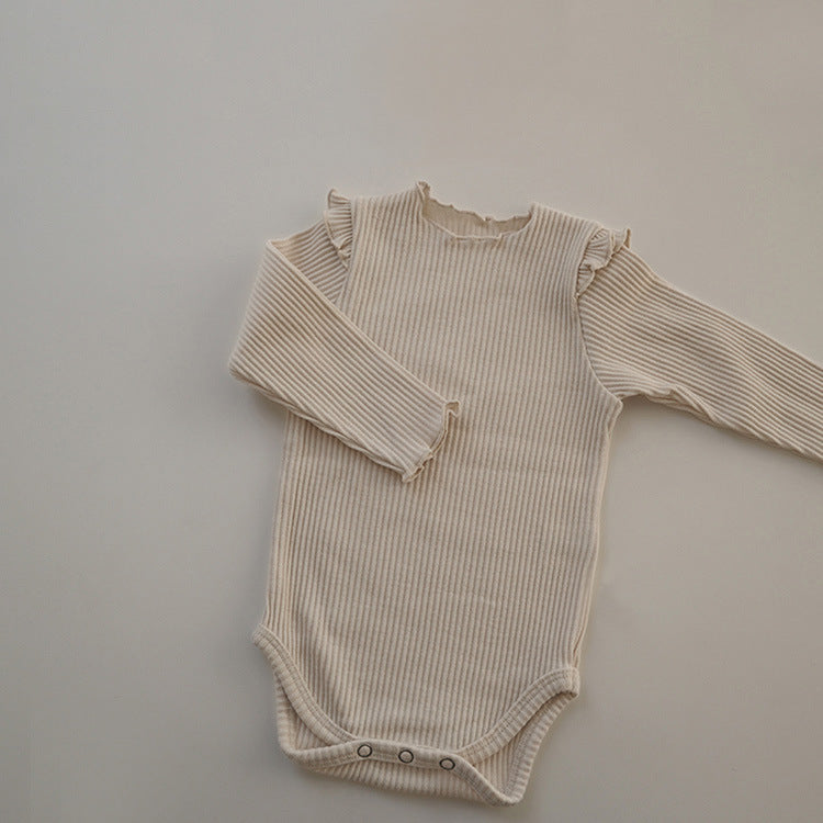 Baby girl long sleeve bodysuit in solid colors with lettuce trim design, showcasing comfort and style.