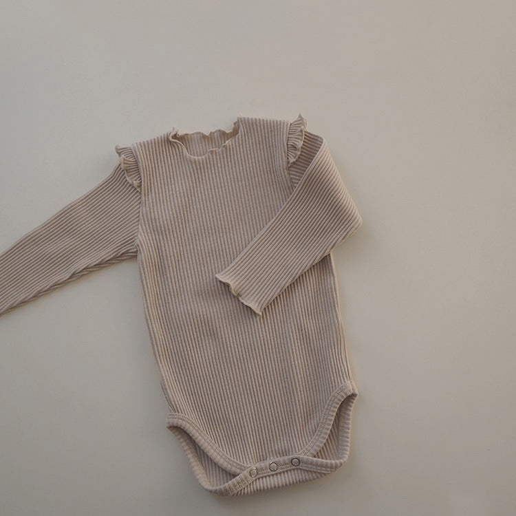 Baby girl long sleeve bodysuit in solid colors with lettuce trim design, showcasing comfort and style.