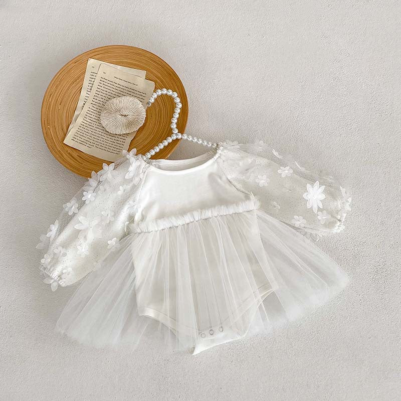 Baby girl dress in solid colors with mesh patches, available in white and apricot, made from soft cotton fabric.