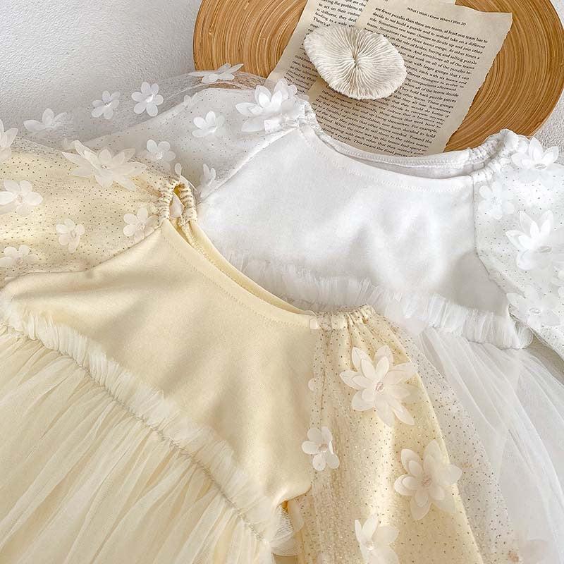 Baby girl dress in solid colors with mesh patches, available in white and apricot, made from soft cotton fabric.