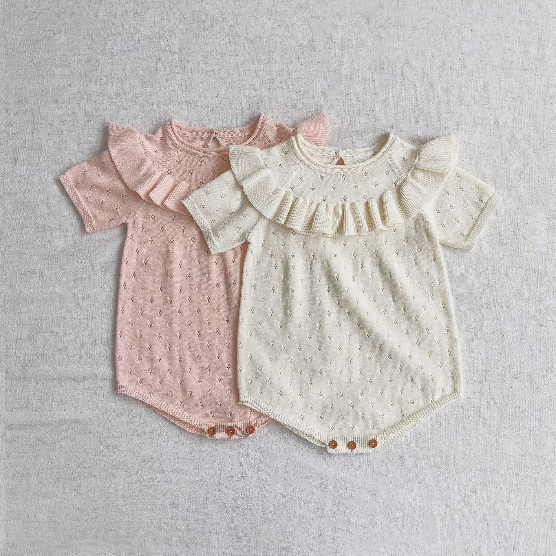 Baby girl solid color knitted onesies with ruffle design in white and pink, made from breathable cotton.