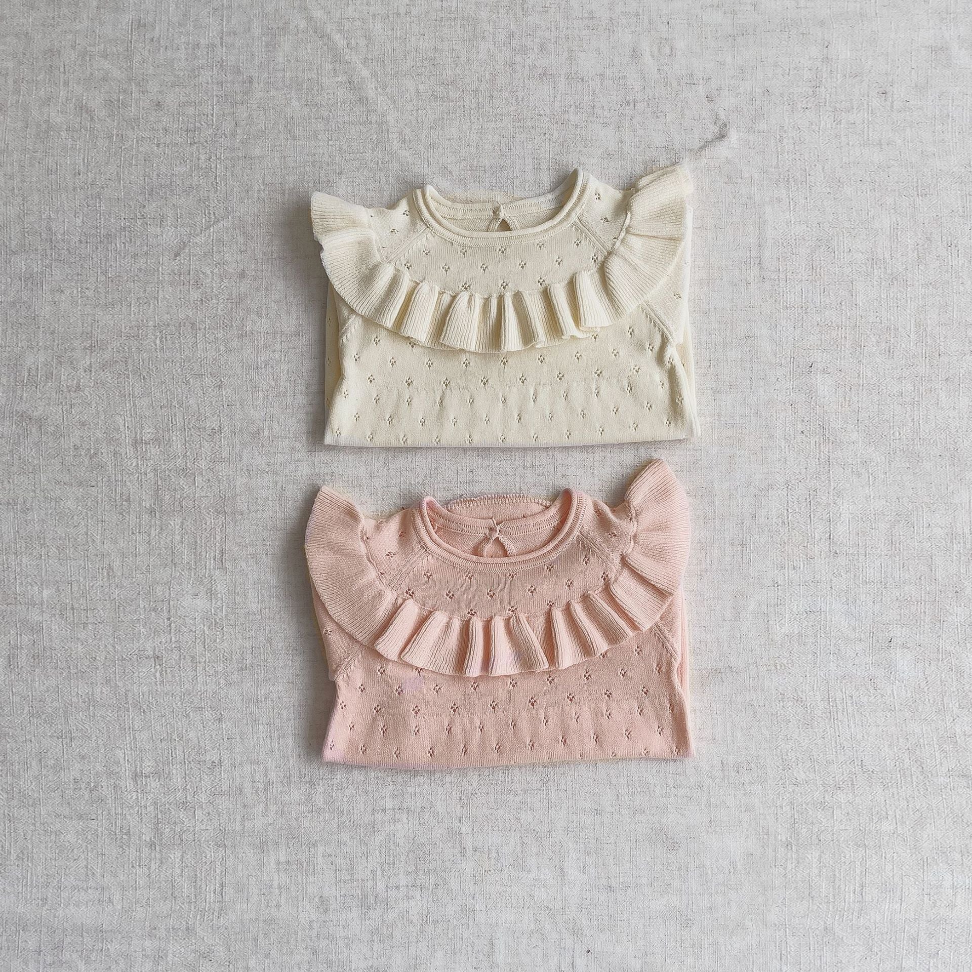 Baby girl solid color knitted onesies with ruffle design in white and pink, made from breathable cotton.