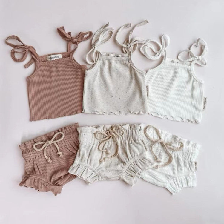 Baby Girl Solid Color Sling Triangle Shorts Set in white, pink, and grey, showcasing soft cotton fabric and adjustable straps.