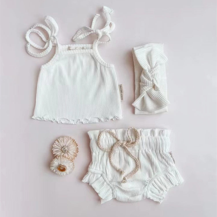 Baby Girl Solid Color Sling Triangle Shorts Set in white, pink, and grey, showcasing soft cotton fabric and adjustable straps.