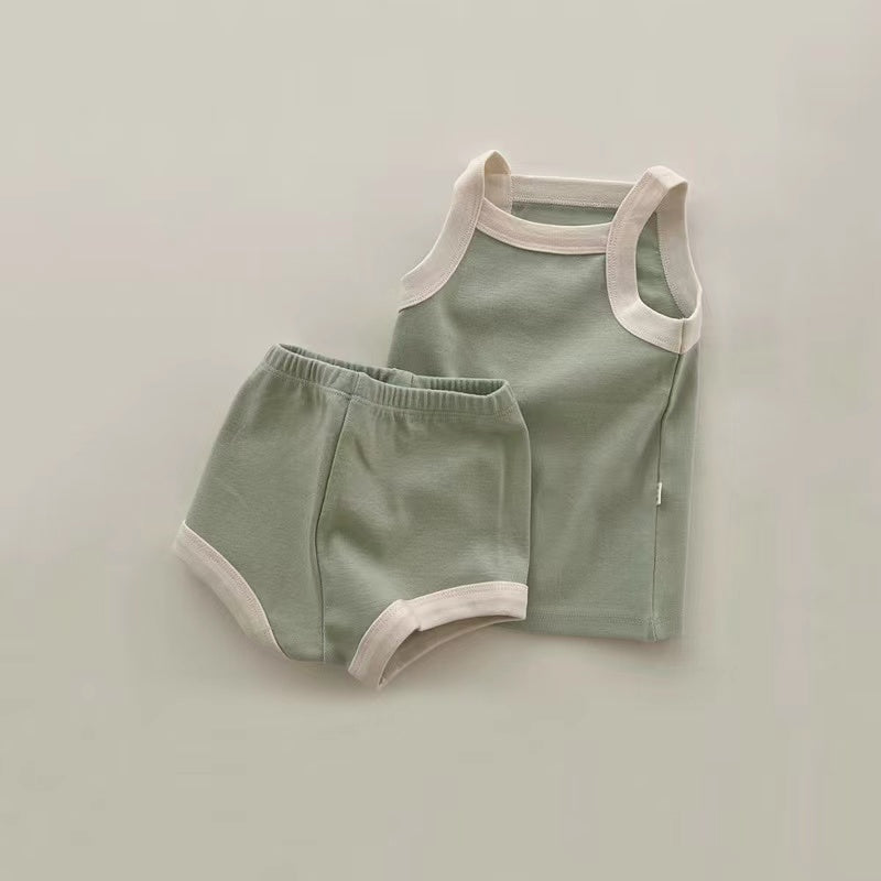 A stylish 2-piece baby girl outfit featuring a pure cotton vest and shorts in vibrant colors, perfect for summer wear.