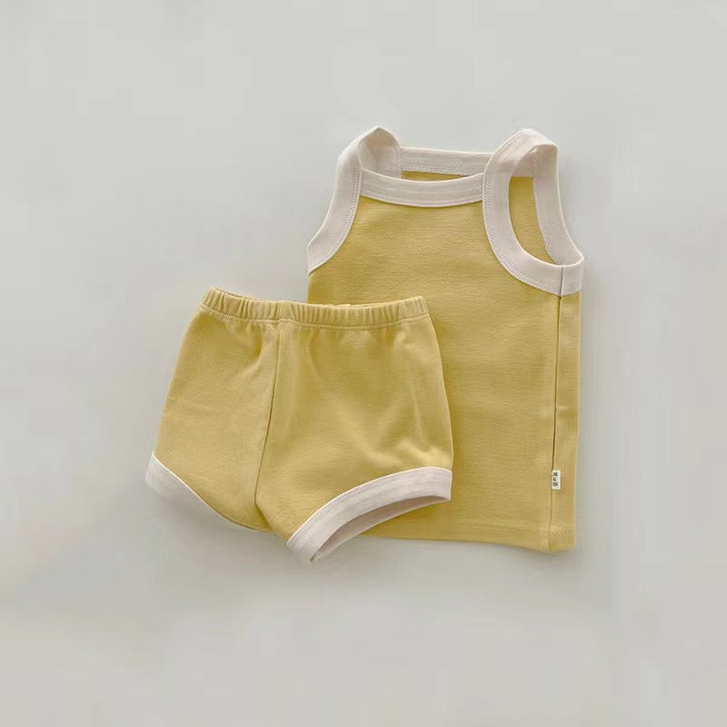 A stylish 2-piece baby girl outfit featuring a pure cotton vest and shorts in vibrant colors, perfect for summer wear.