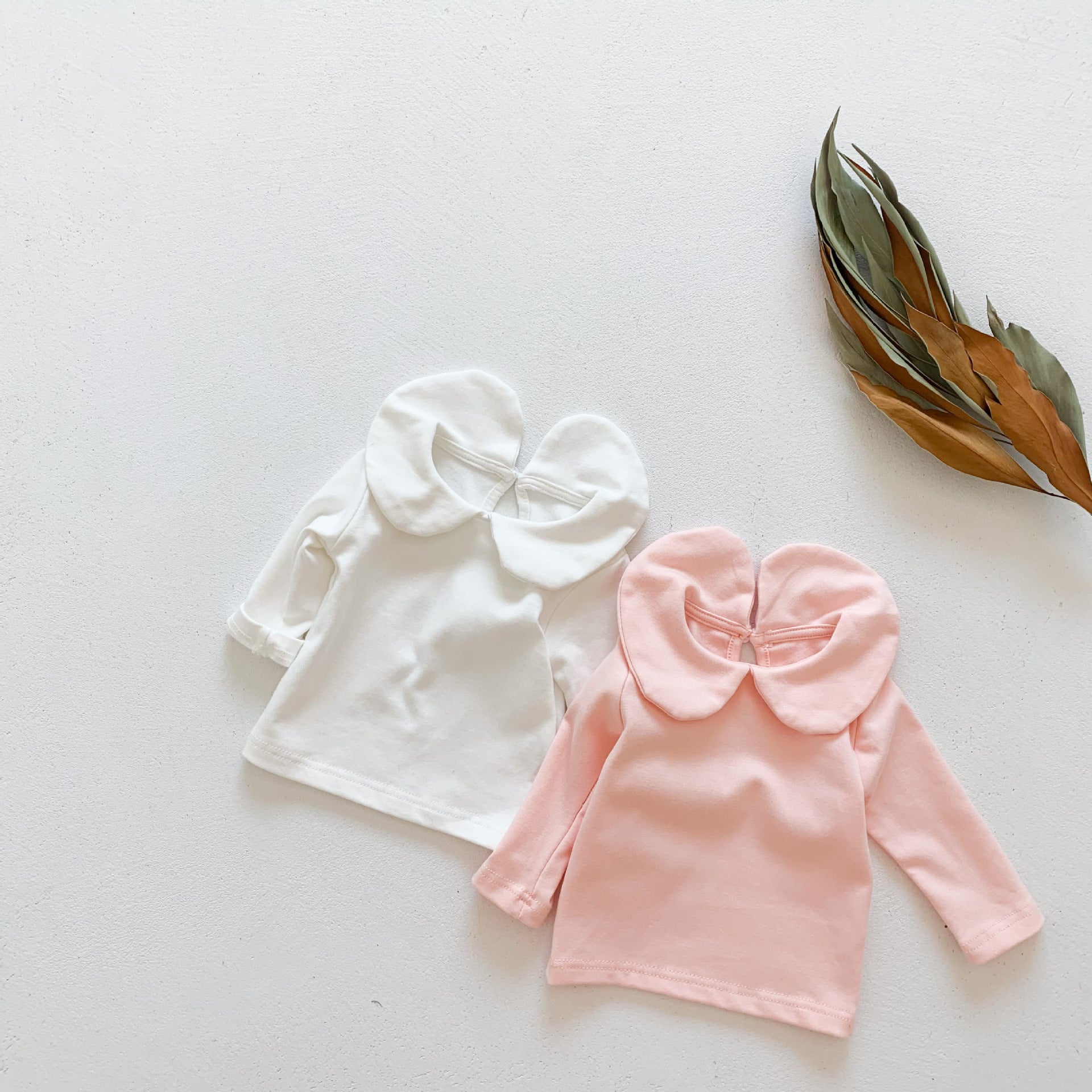 Baby girl solid doll collar top in white and pink, made from soft cotton blend, featuring a fitted silhouette and distinctive collar.