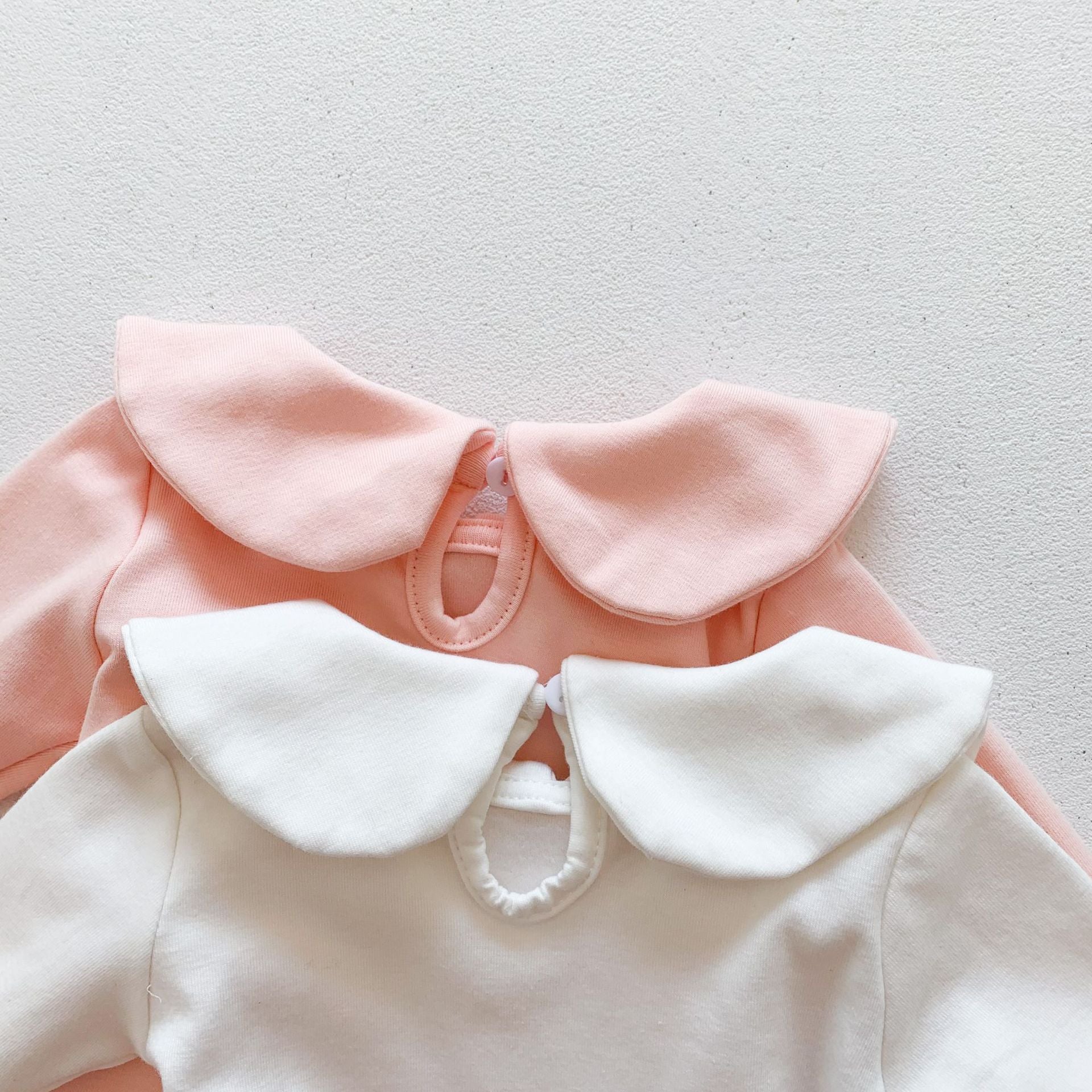 Baby girl solid doll collar top in white and pink, made from soft cotton blend, featuring a fitted silhouette and distinctive collar.