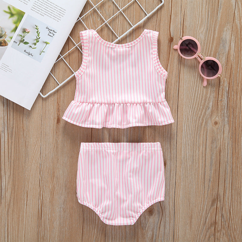 Baby girl striped graphic swimsuit with ruffle top and shorts, available in pink and blue.