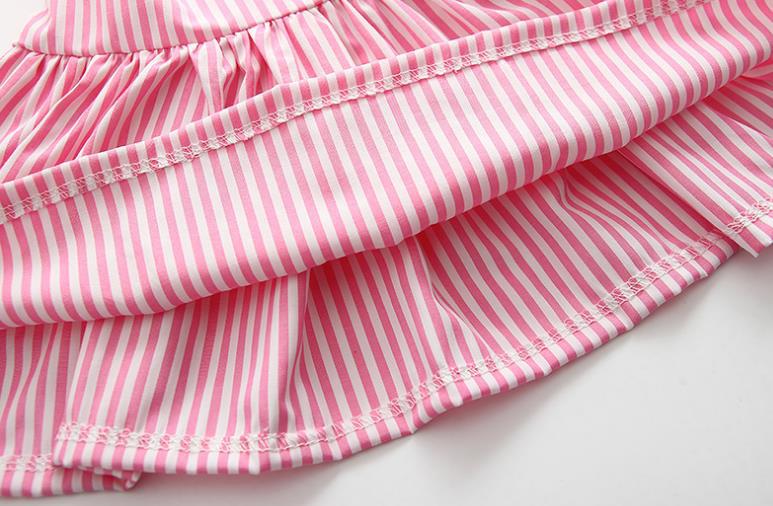 Baby girl wearing a striped pattern dress combo with shorts, showcasing a playful and stylish summer outfit in pink and blue.