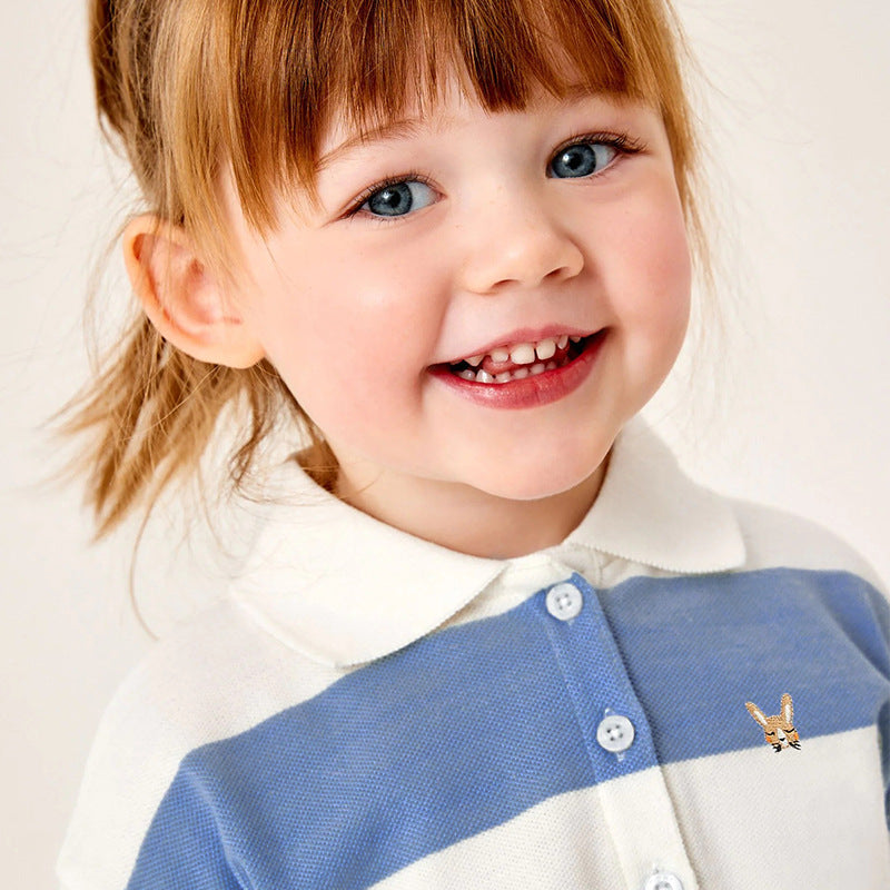 Baby girl wearing a blue striped polo neck shirt with a pleated skirt, perfect for summer outings.