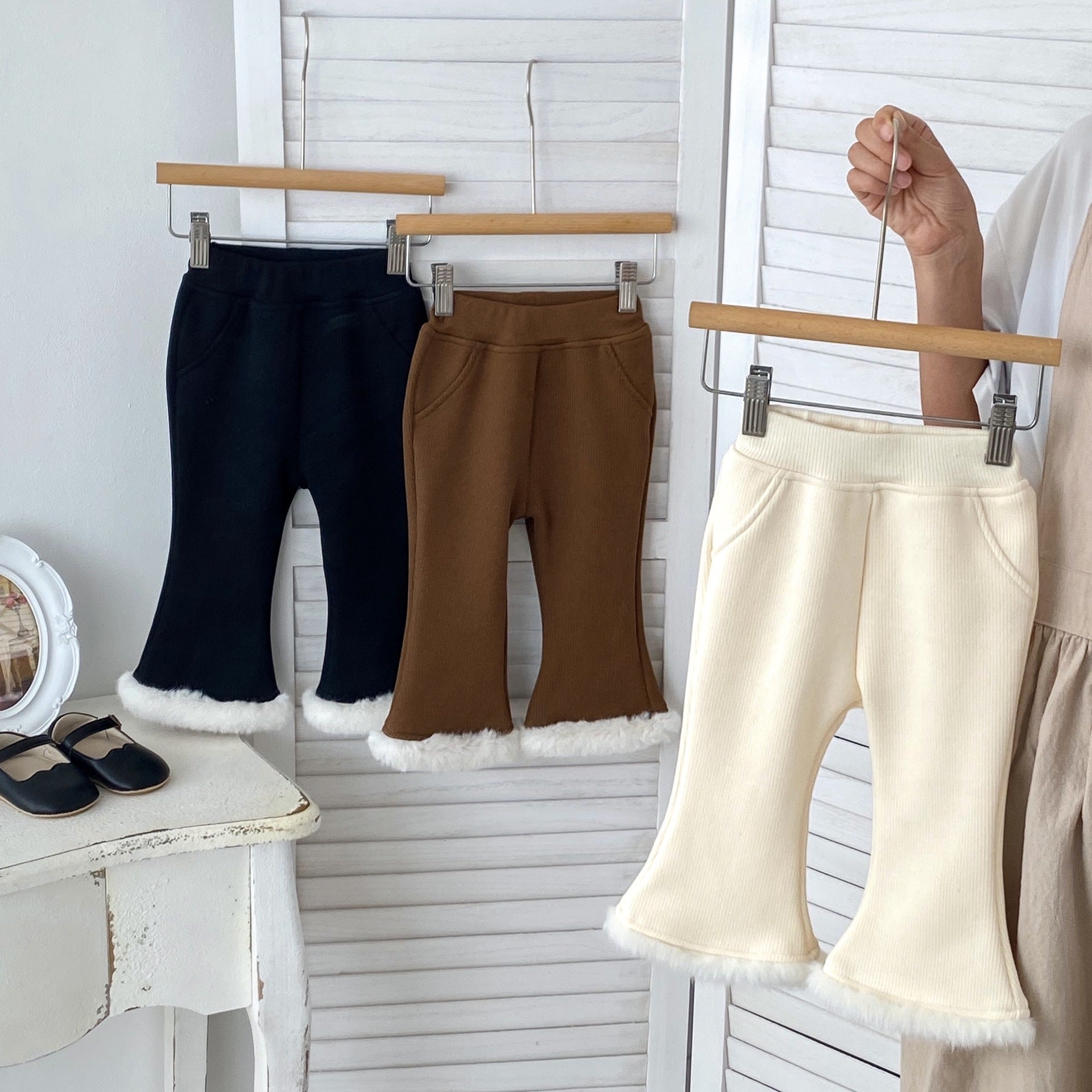 Baby girl velvet-in solid winter pants in black, beige, and brown colors, showcasing soft fabric and elastic waistband.