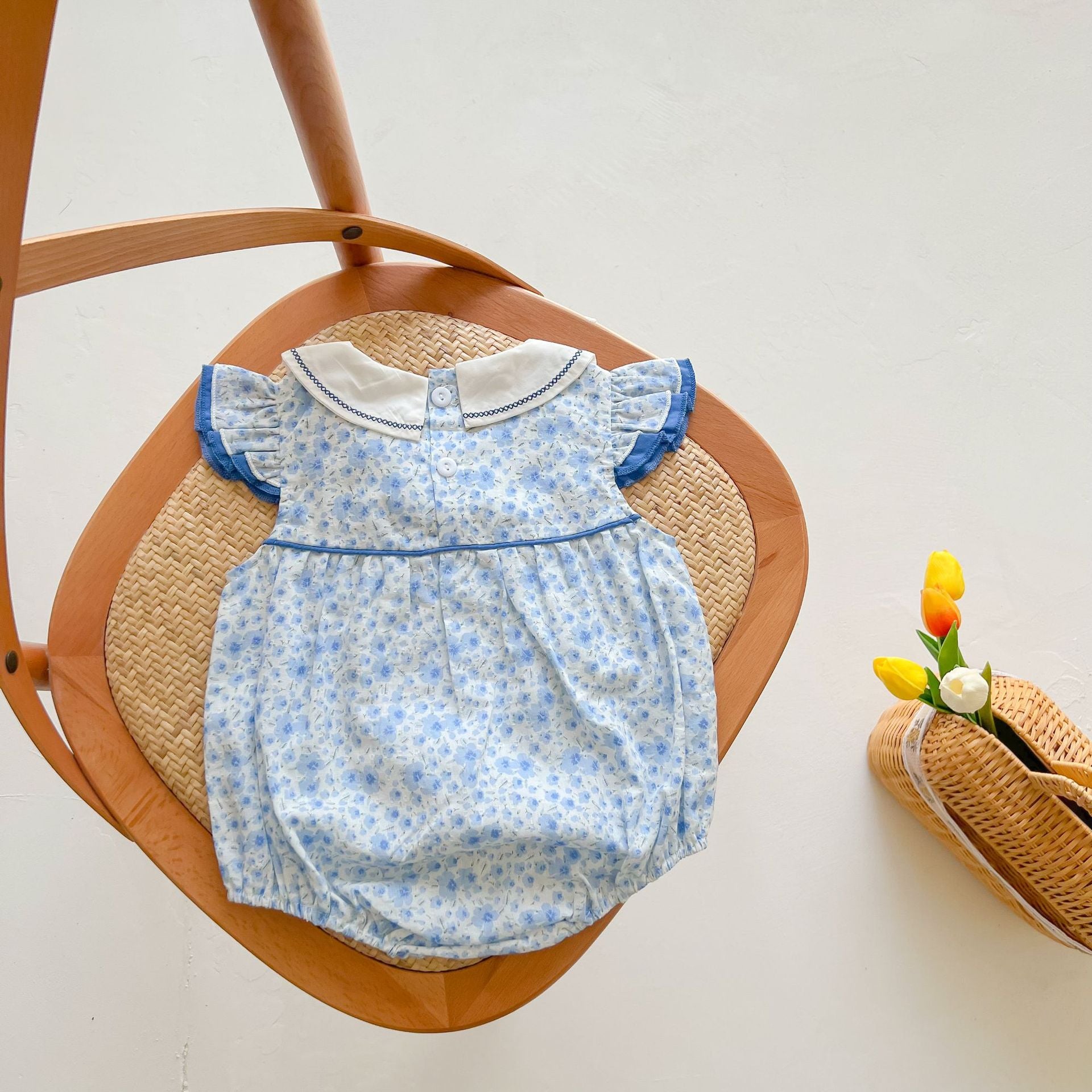 Baby girls floral print onesie with embroidered design and ruffle sleeves in blue, perfect for summer wear.