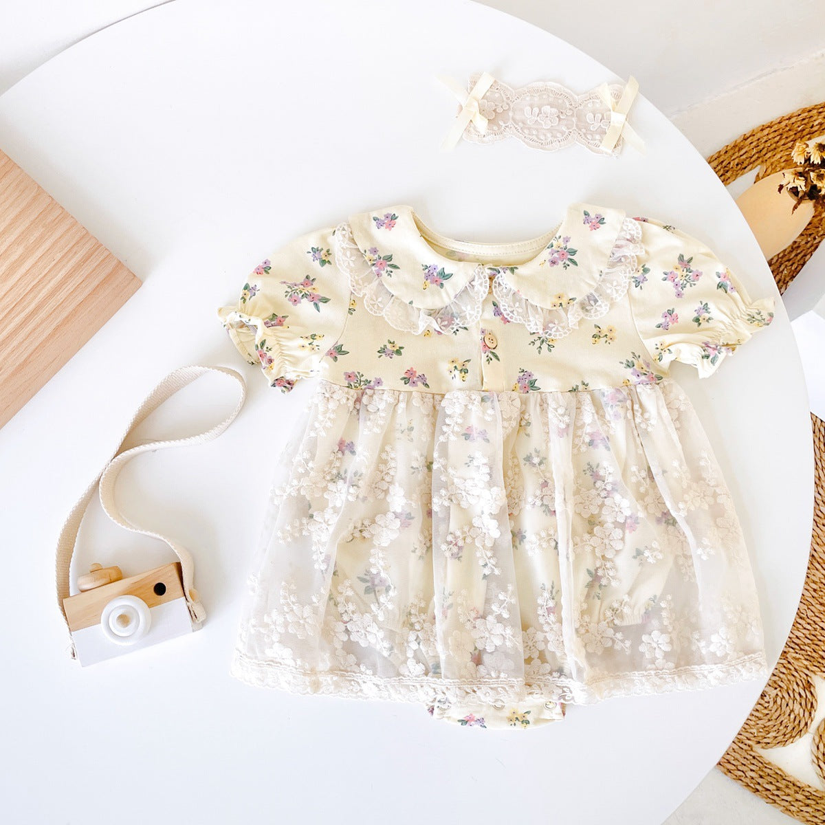 Baby girls floral print dress with embroidered lace patchwork and doll-neck design in apricot color.