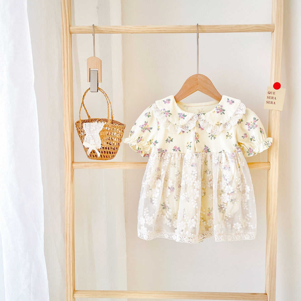 Baby girls floral print dress with embroidered lace patchwork and doll-neck design in apricot color.