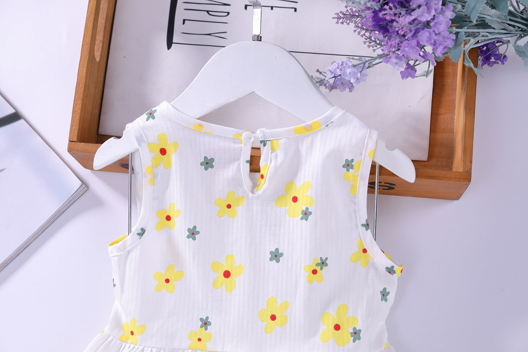 A beautiful baby girls floral print sleeveless dress featuring vibrant colors and a round collar, perfect for summer occasions.