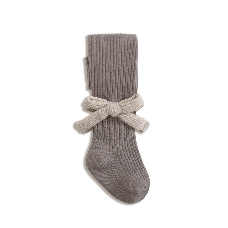 A collection of Baby Girls Kids Solid Color Striped Pattern Design Knitting Bows in white, black, grey, and khaki, showcasing their stylish design.