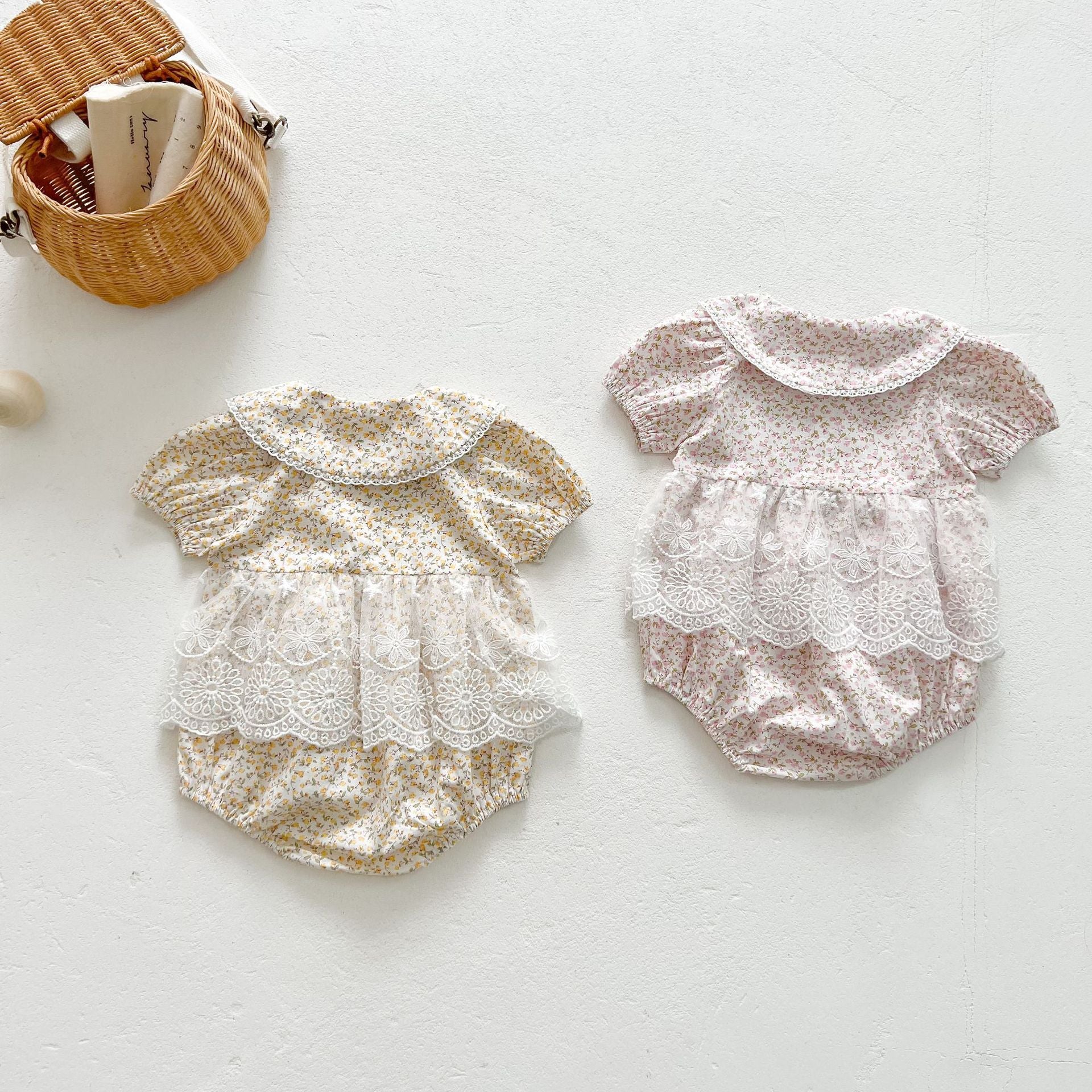 Baby girls floral print onesie featuring a doll collar and gauze skirt, available in pink and yellow.