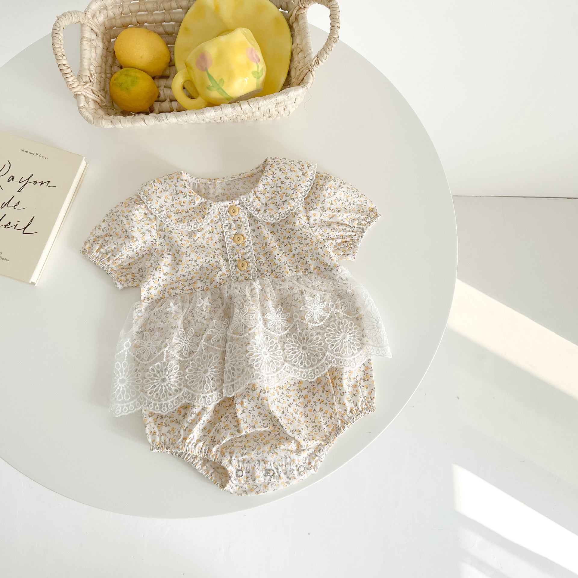 Baby girls floral print onesie featuring a doll collar and gauze skirt, available in pink and yellow.