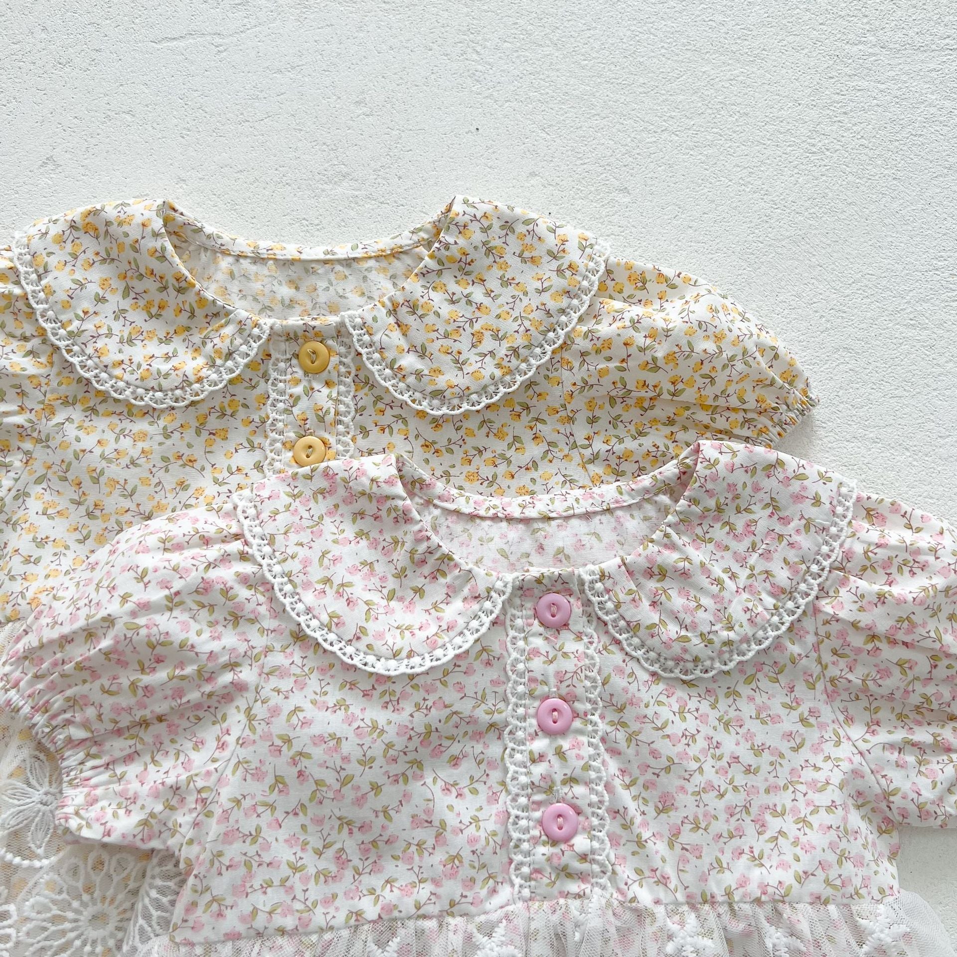 Baby girls floral print onesie featuring a doll collar and gauze skirt, available in pink and yellow.