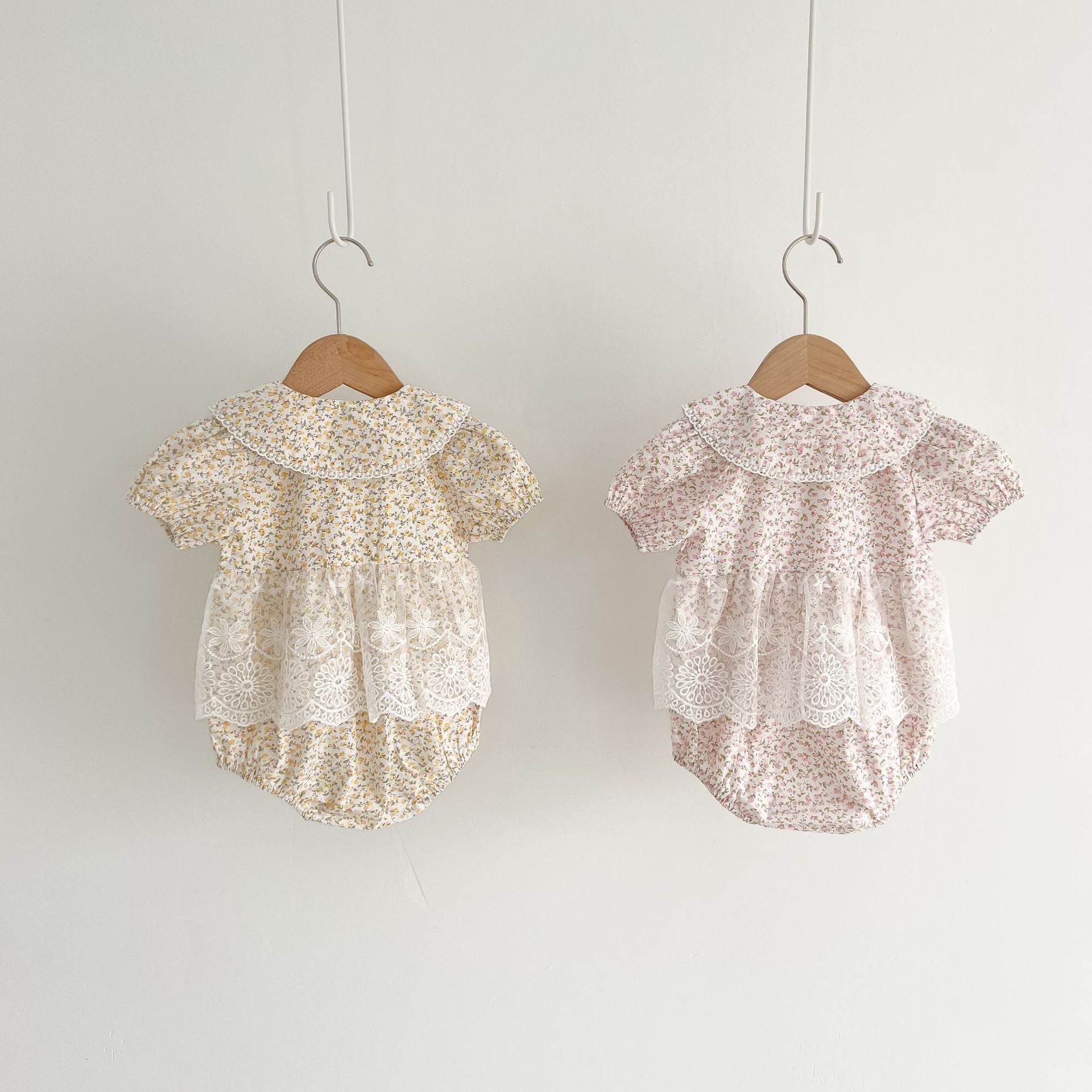 Baby girls floral print onesie featuring a doll collar and gauze skirt, available in pink and yellow.